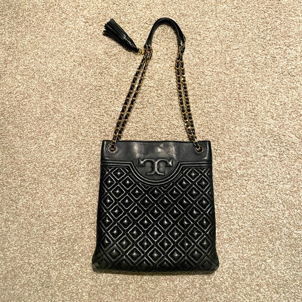 Tory Burch black handbag with gold chain.